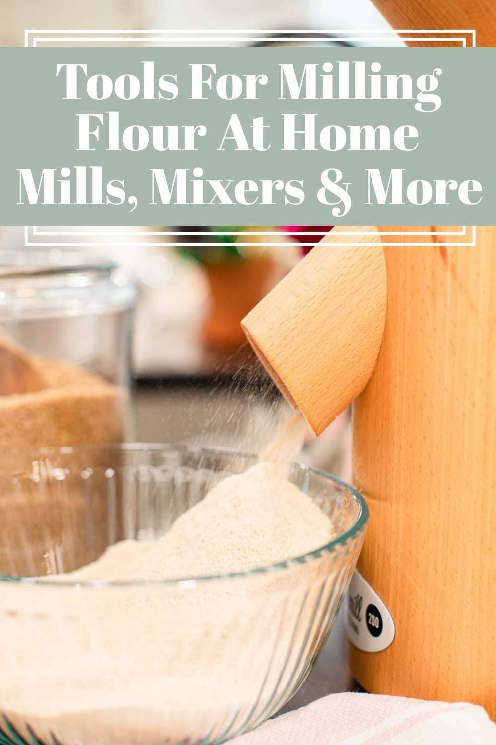 Wooden grain mill dispensing freshly milled flour into glass bowl on cottage kitchen counter, design with text about tools for milling flour at home including mills and mixers